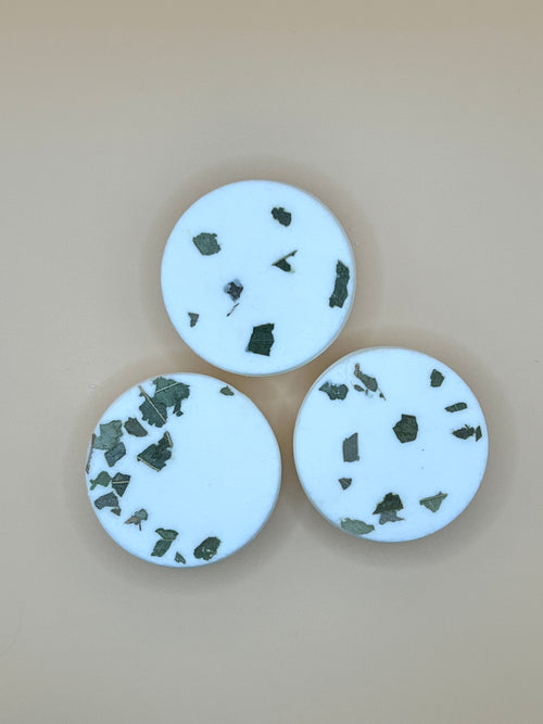 Three shower steamers on a beige background